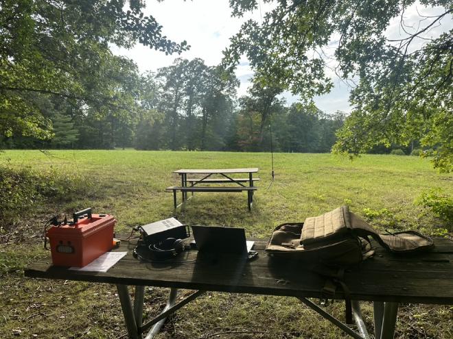 Image of my setup for this trip showing my Radio, laptop and backpack on a bench